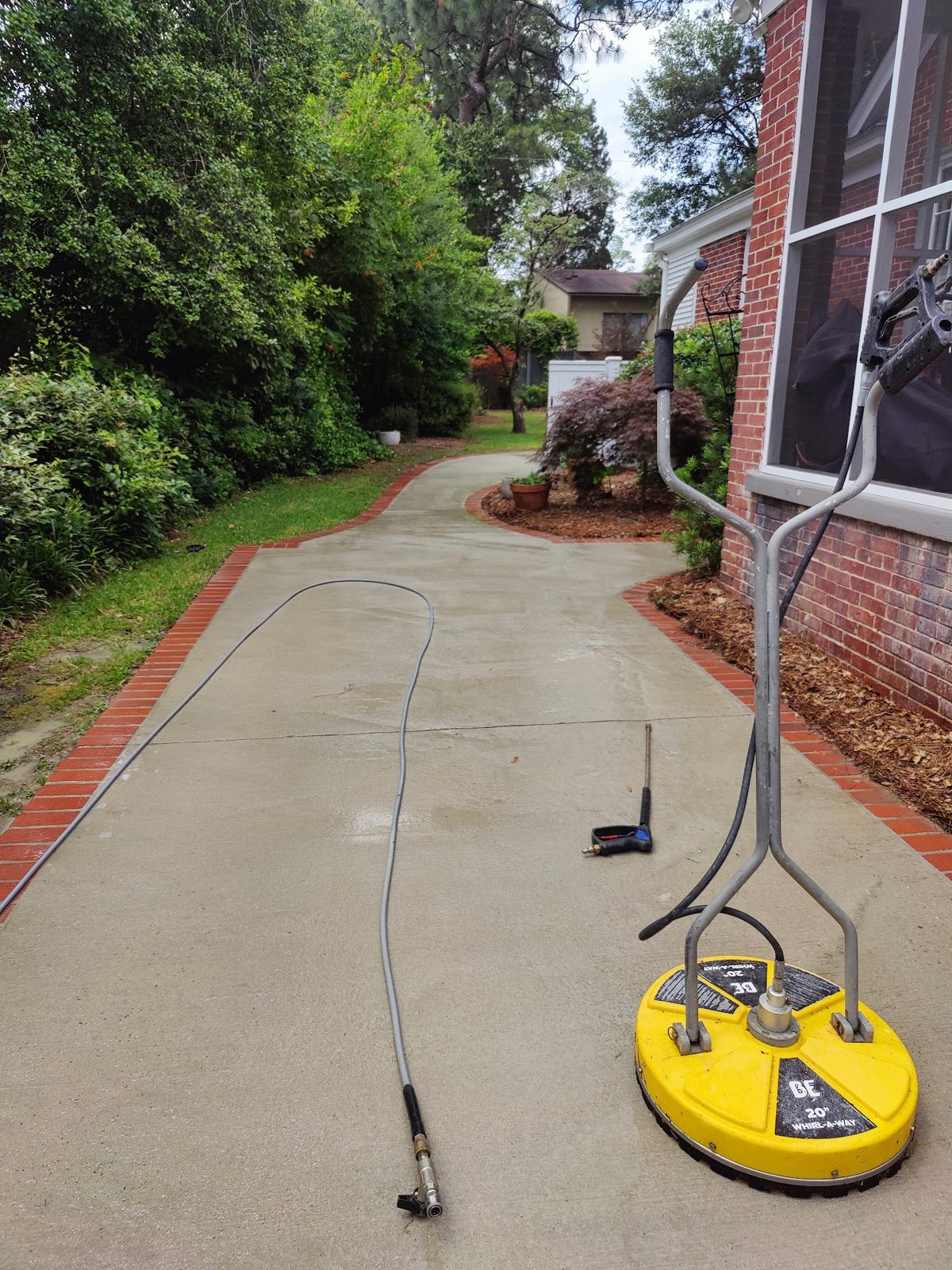 A concrete driveway before and after a Soda City surface clean