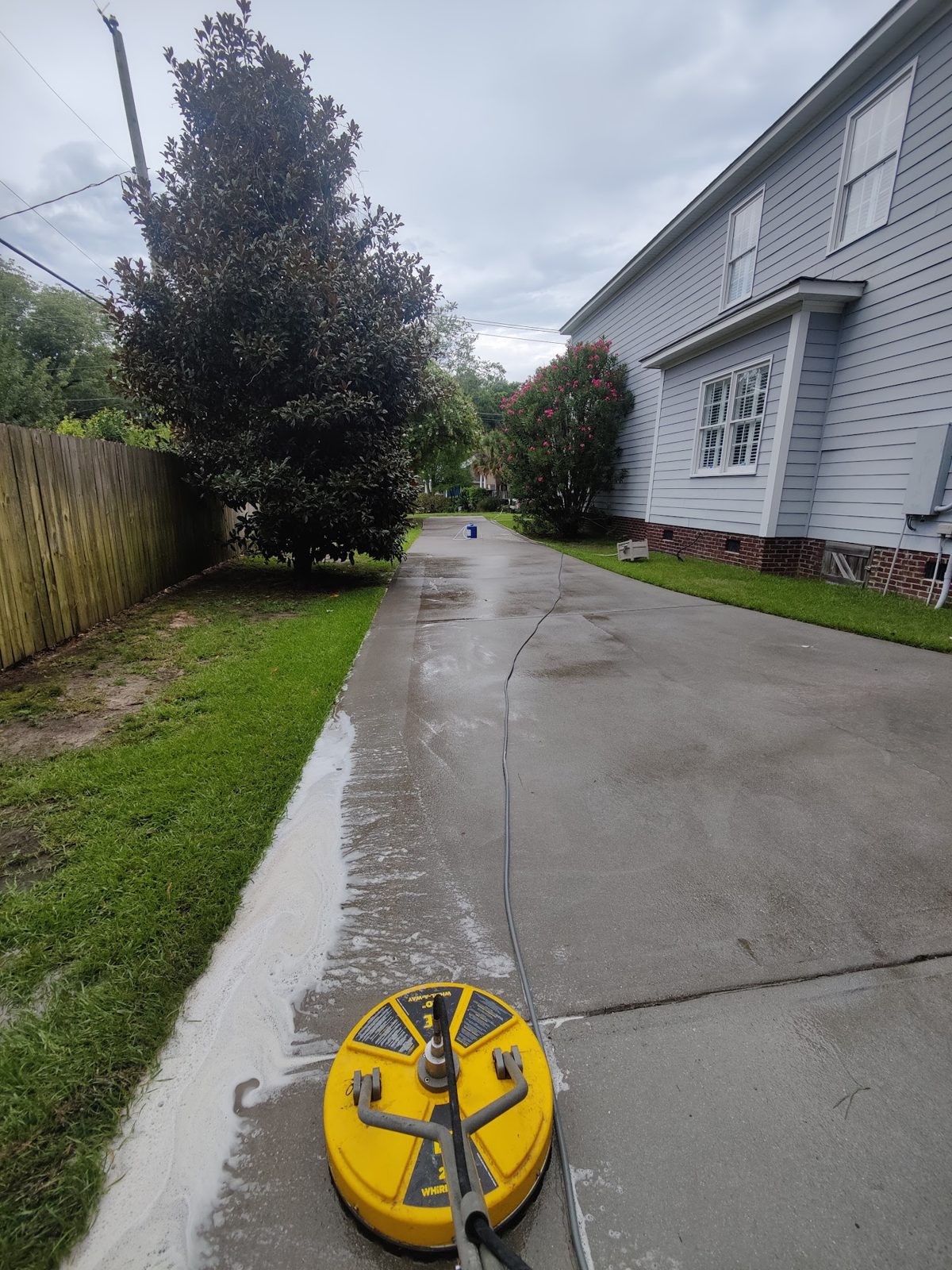 A concrete driveway before and after a Soda City surface clean