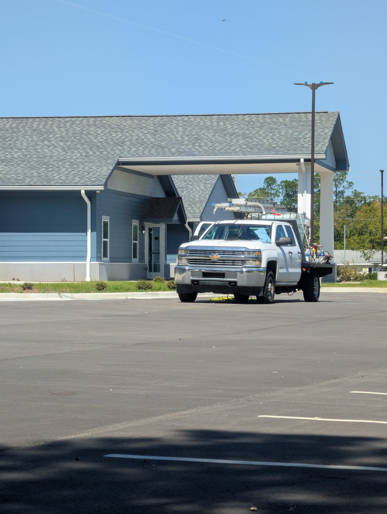 The Soda City truck in the parking lot of a blue commercial building